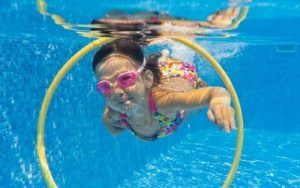 11753742-happy-smiling-underwater-child-in-swimming-pool-little-girl-swims-kids-sport-1080x675