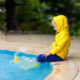 kid in a raid coat by the pool after a storm
